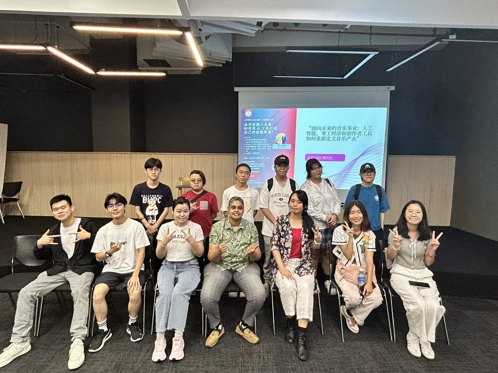 Kay with participants after an AI and music careers sharing session, in front of the presentation screen
