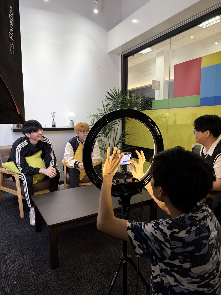 Young creatives setting up a ring light and phone for a video interview shoot